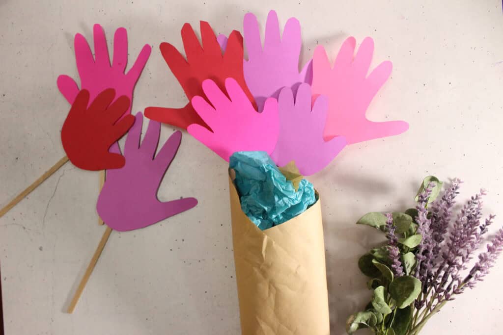step 5- add finishes touches to your mother's day handprint flower bouquet craft for toddlers