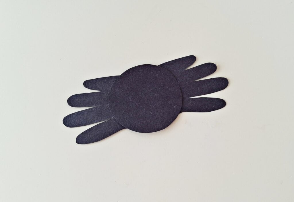Handprint Spider Steps (11)
Join the Handprints
Cut out a medium-sized circle (or oval) from black paper. 